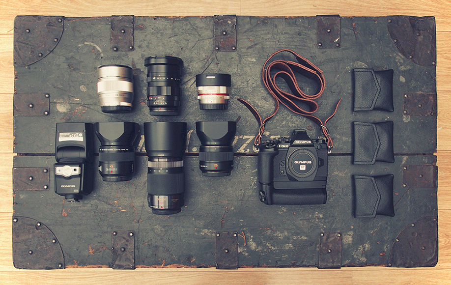 The mirrorless camera gear of street photographer Nicholas Goodden. Street photography relies on the fast autofocus of this Olympus OM-D E-M1 (with battery grip).