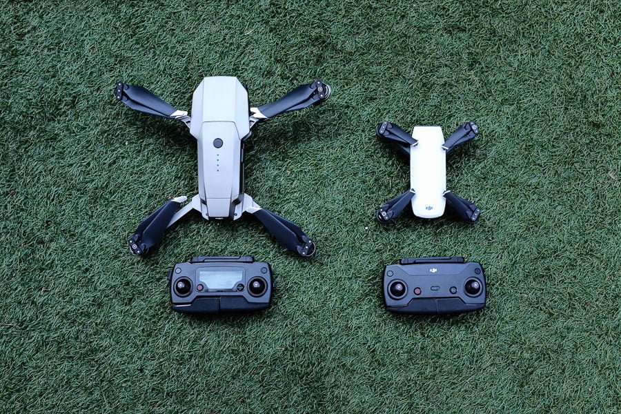 2 drones with controllers on grass