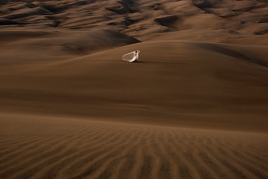 bride in desert dunes