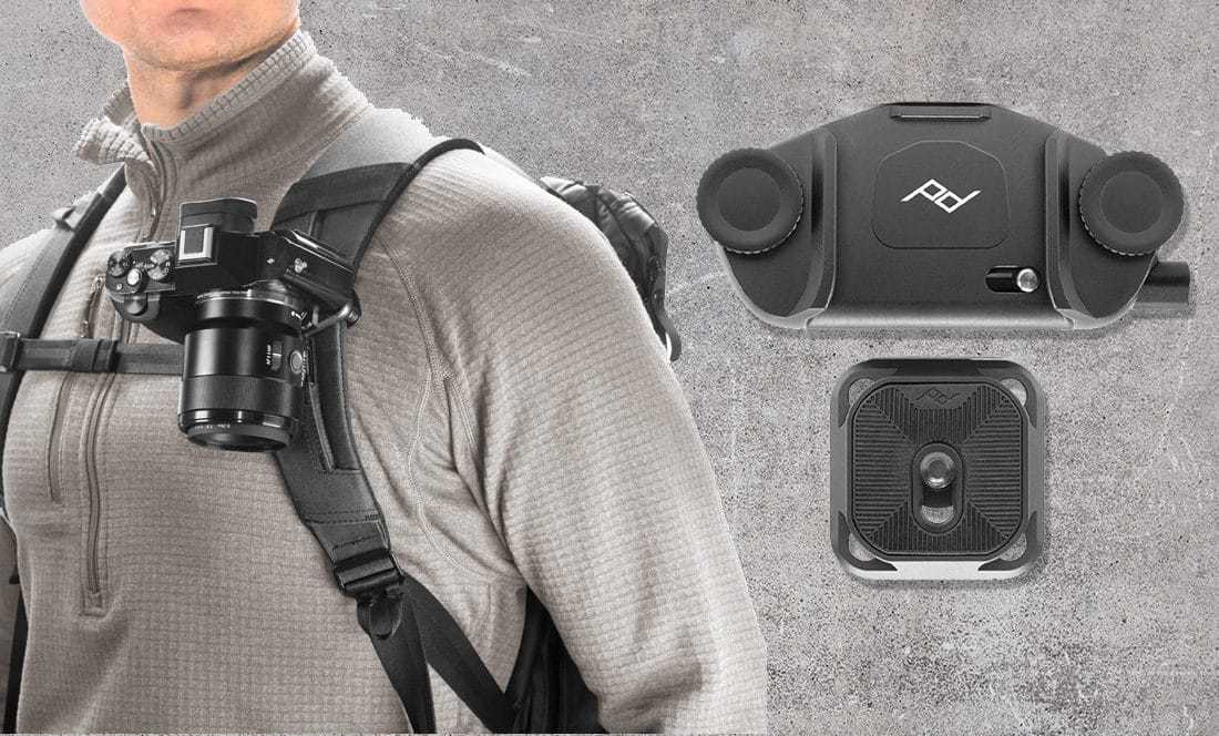 close up of man's shoulder with backpack and peak design capture clip holding camera to strap