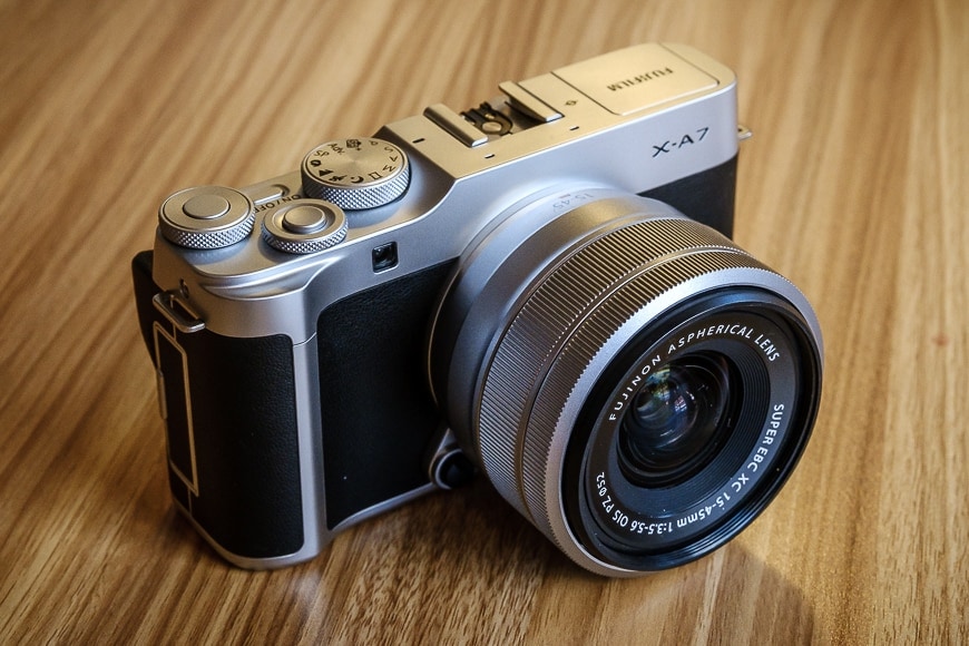 Fuji X-A7 mirrorless camera on table with lens attached