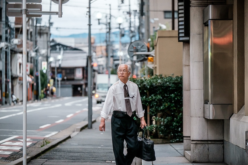 Japanese salary man walks down street