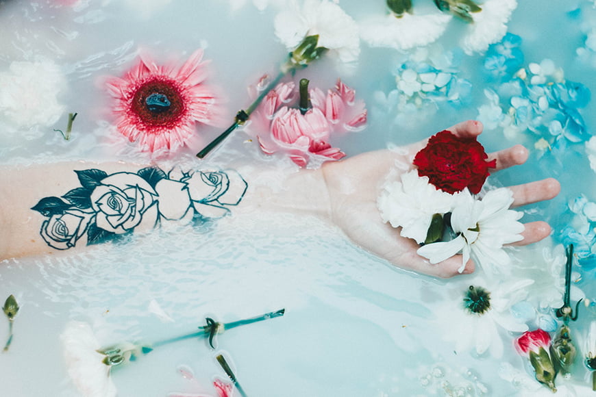 Milk bath photography ideas - floating arm in a milk bath with flowers