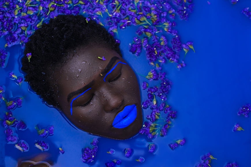 Models head submerged in a coloured milk bath