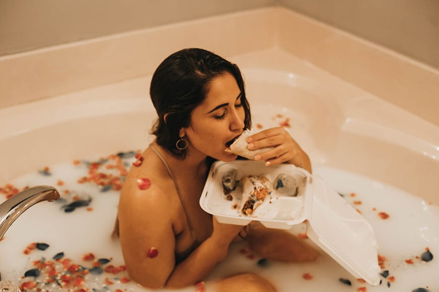 Model eating in a milk bath