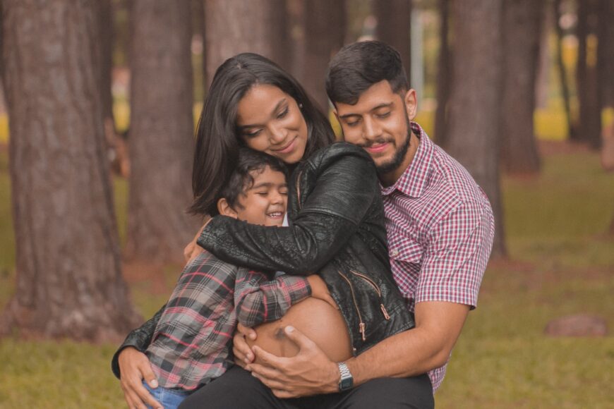 Portrait photography - a family hugging with trees as background