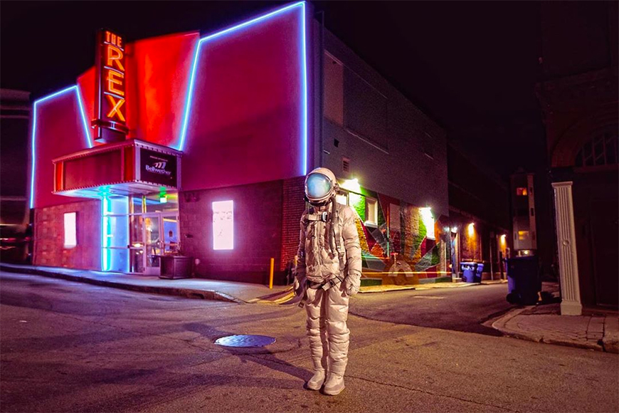 Astronaut outside a theatre.