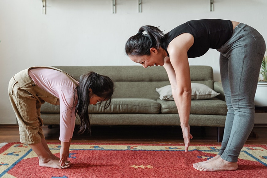 mother and daughter photo shoot doing yoga stretches