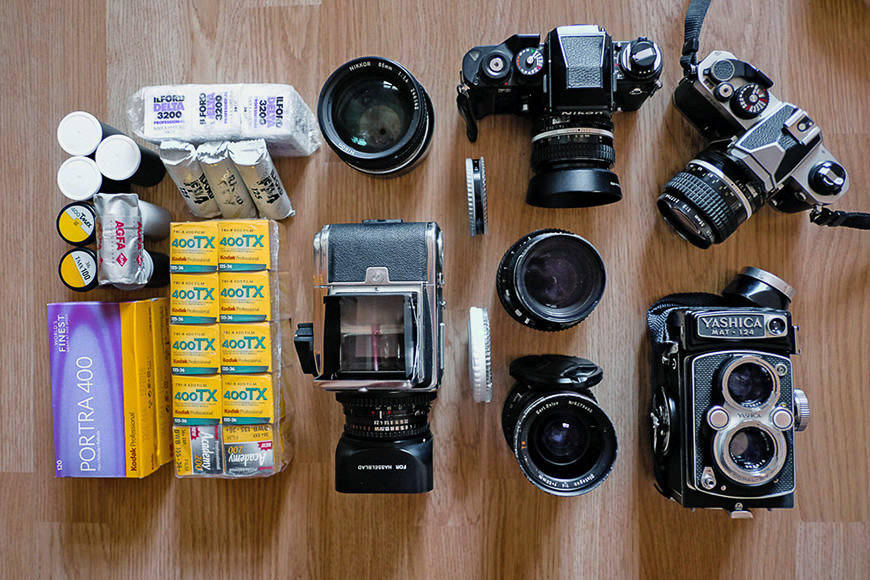 Flat lay of analog cameras and color film