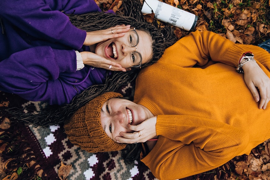 Photo of best friends lying down smiling