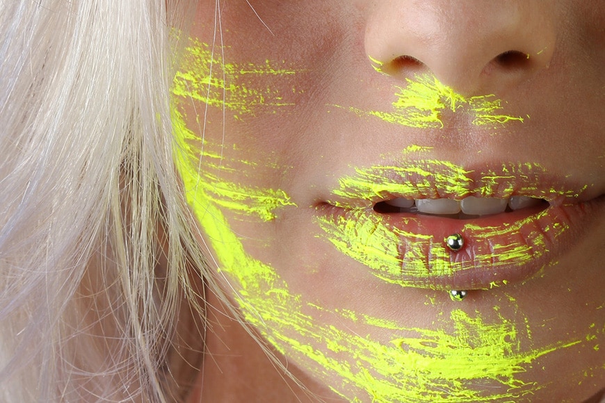Face closeup with yellow paint