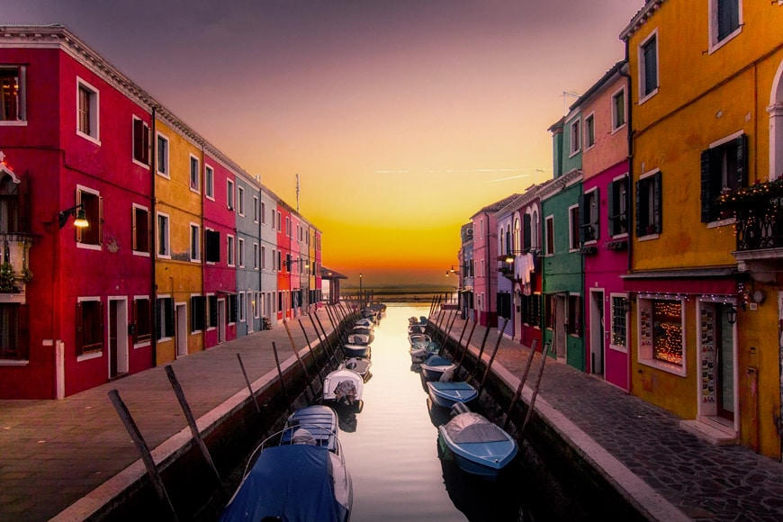 Colorful buildings over looking a canal with boats