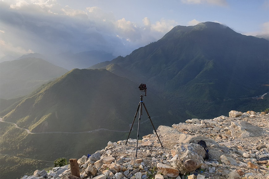 photography hdr - a tripod on a rocky mountain top 