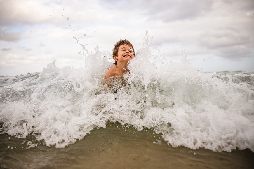 boy playing in waves