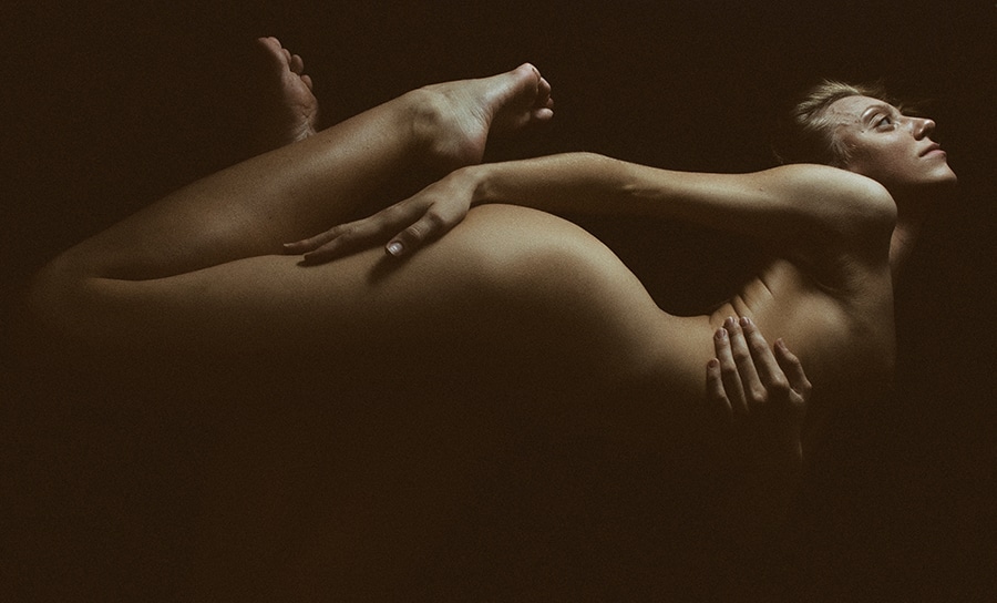 Nude photography with female model shot from below