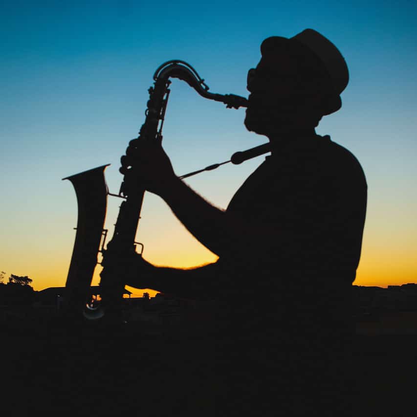 Saxaphone player silhouette against sunset sky