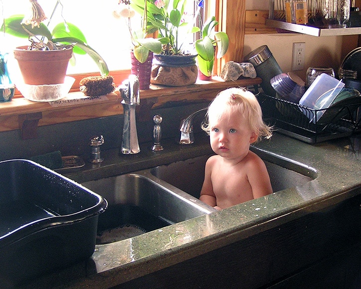 Portrait of a child bathing in the sink