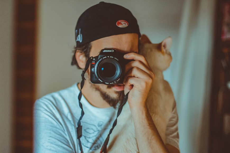 cat on shoulder with photographer