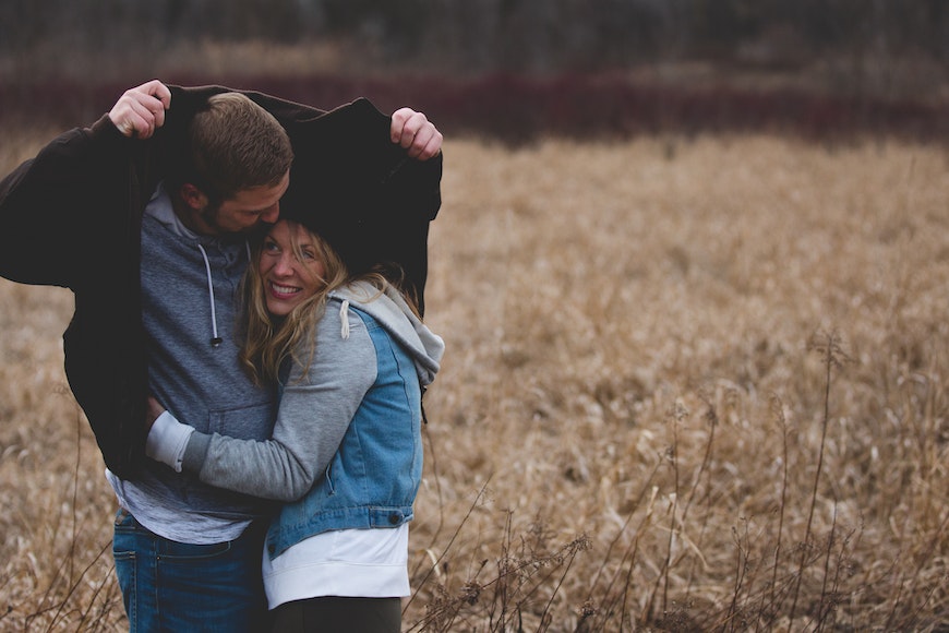 A Young Couple Hugging and Smiling · Free Stock Photo