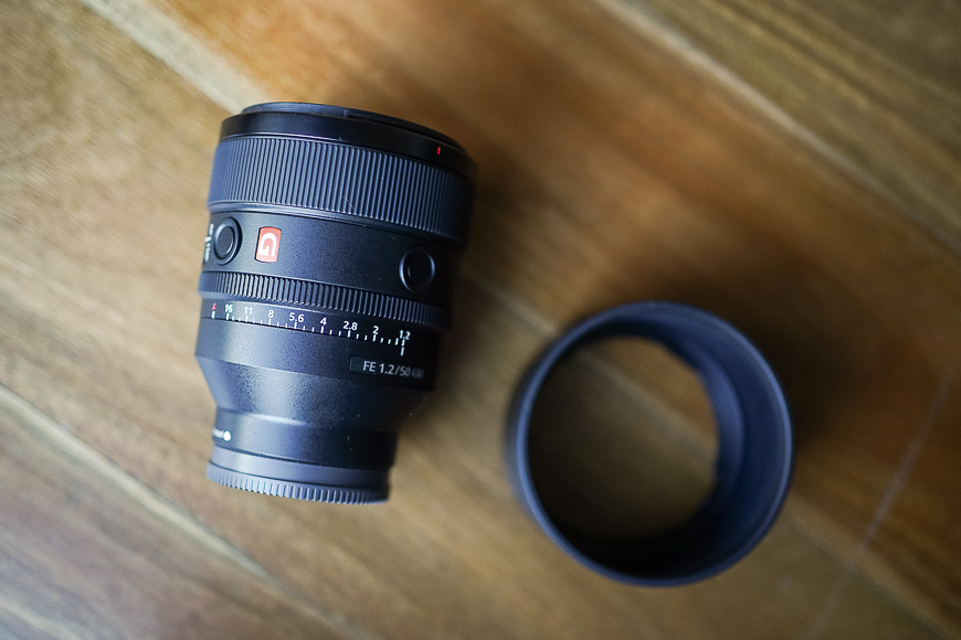 Sony 50mm f/1.2 G Master lens with hood on table