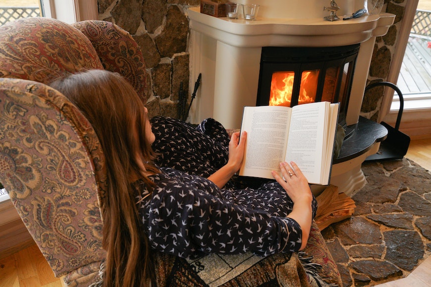Reading book in front of fire