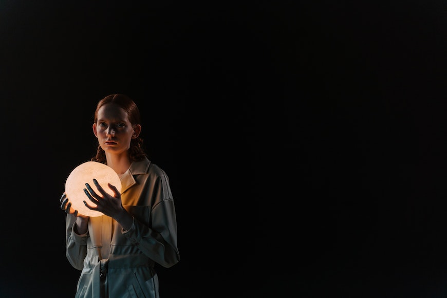 Girl holding illuminated ball