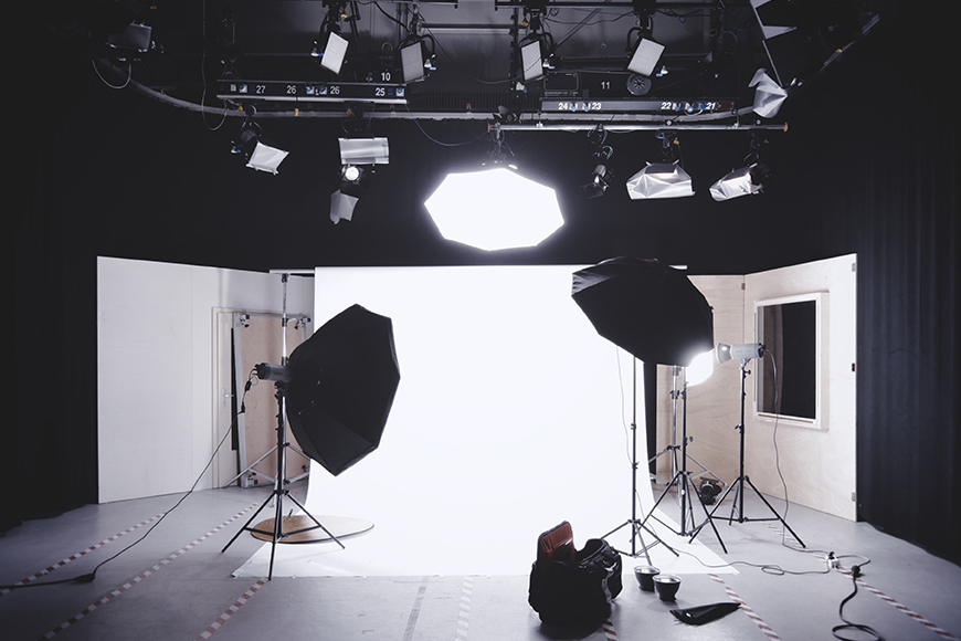 a photo studio with lights and lighting equipment.