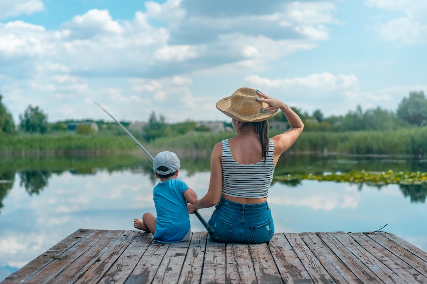 Woman and little boy fishing
