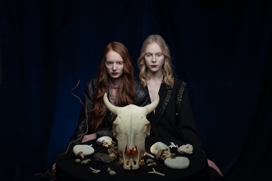 Two girls in black with skull