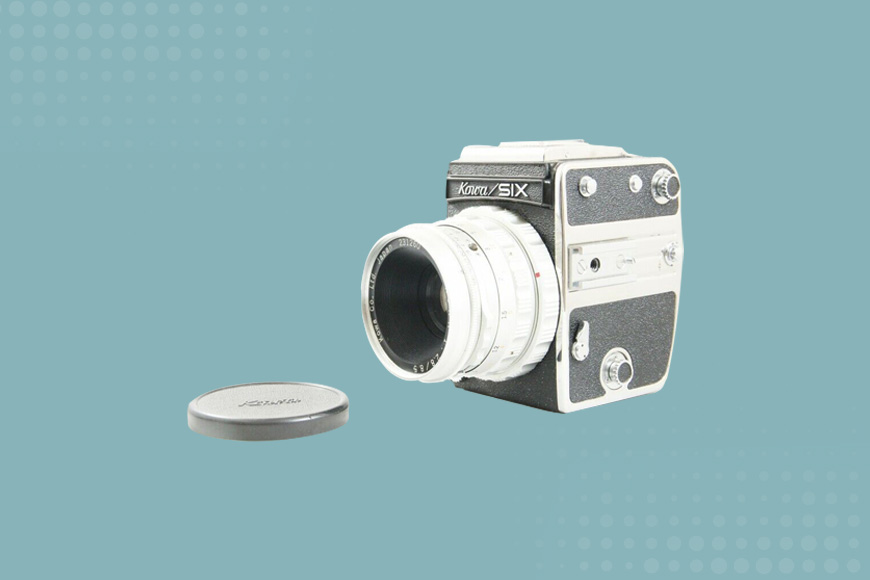 a camera with a lens cap on a blue background.