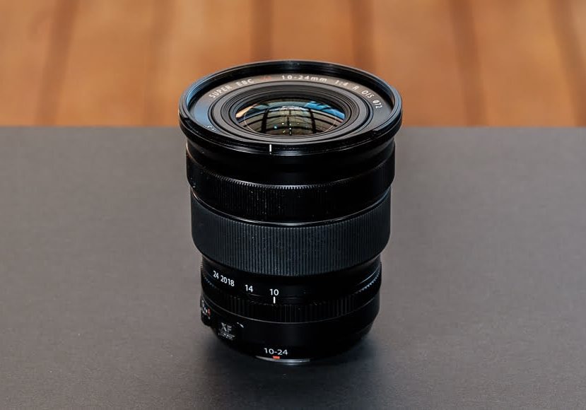a close up of a fuji camera lens on a table.