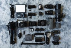 a collection of cameras and other equipment laid out on a fur surface.