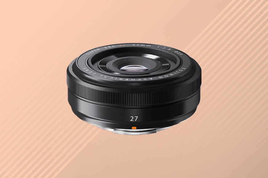a Fujifilm camera lens on a tan background.