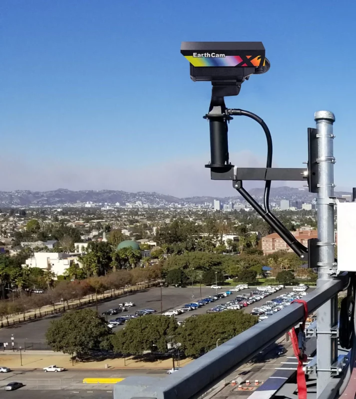 a camera on top of a building with a city in the background.