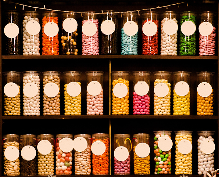 a shelf filled with lots of different types of candies.