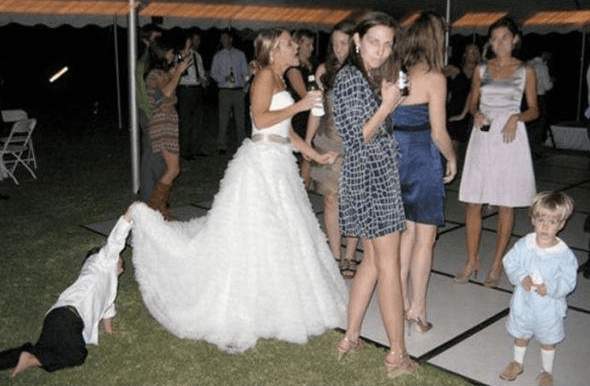 a group of people standing around a woman in a wedding dress.