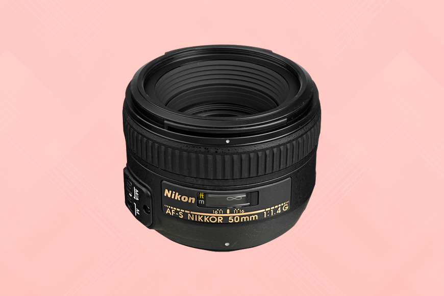 a nikon lens on a pink background.
