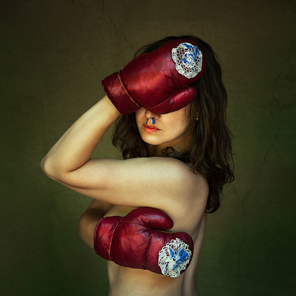 a woman with red boxing gloves on her head.