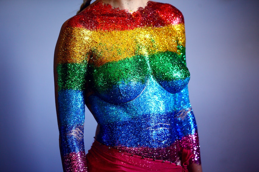 a woman painted in rainbow colors