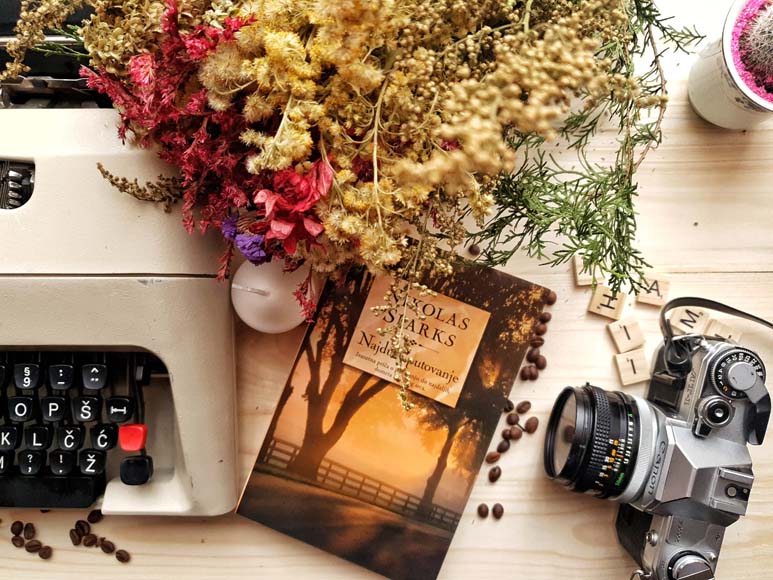 a camera and a book on a table.