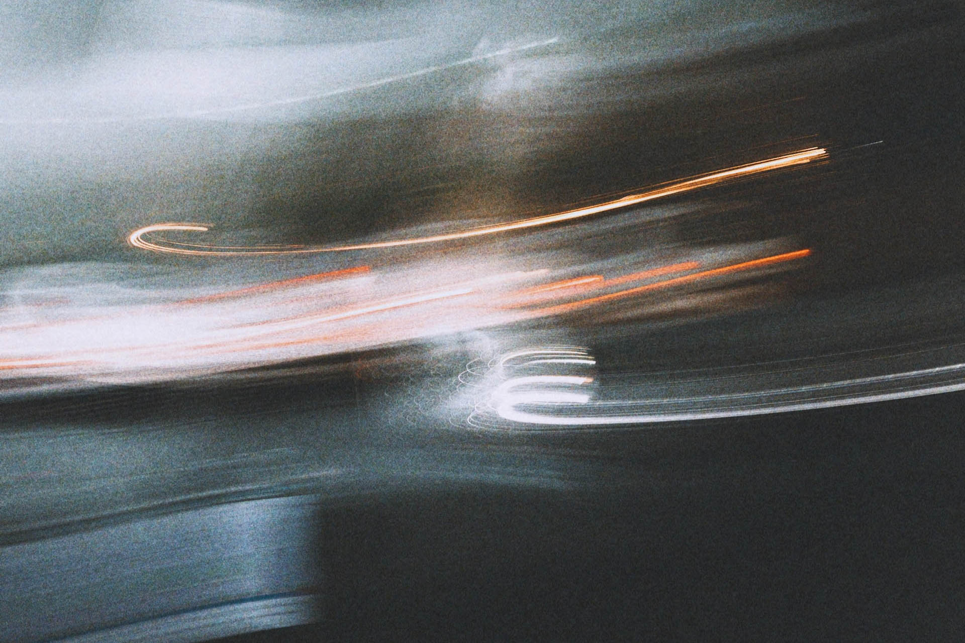 a blurry photo of a car driving down a street.