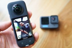 a person holding an insta360 x3 action camera in their hand.