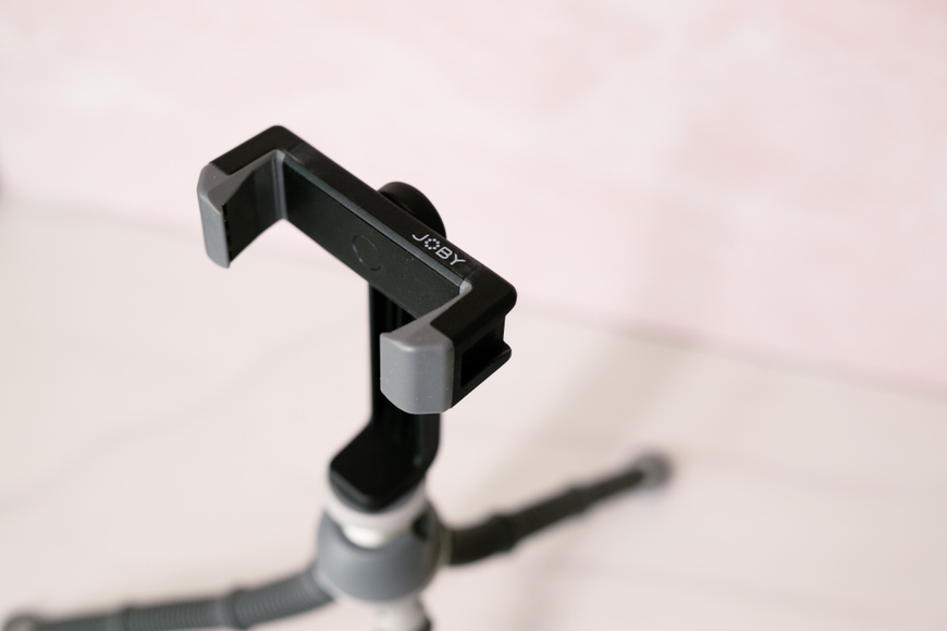 a mini tripod with a phone mount attached to it.