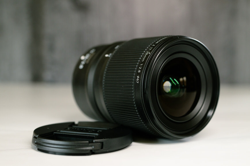 A close up of the front barrel of a camera lens on a table.