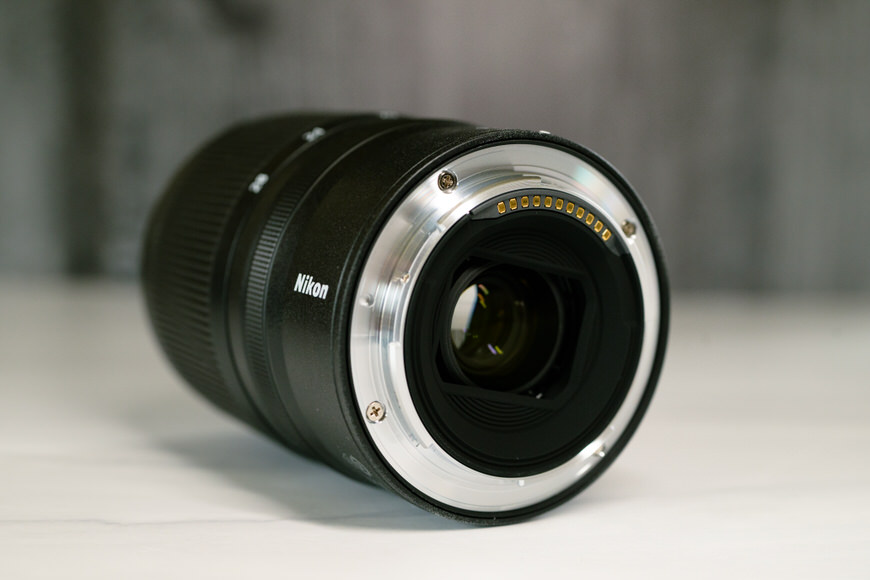 A close up of the metal mount of a camera lens on a table.