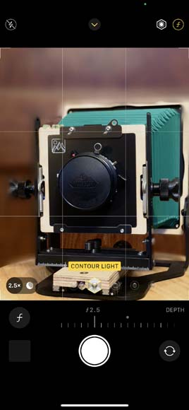 screenshot of Portrait Mode on iPhone showing an image of a camera on a table.