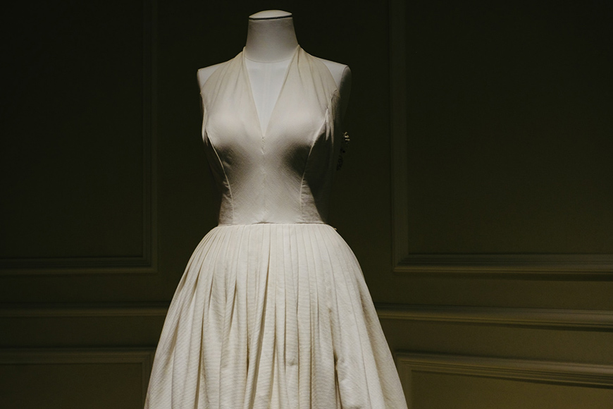 a white dress on a mannequin in a room.
