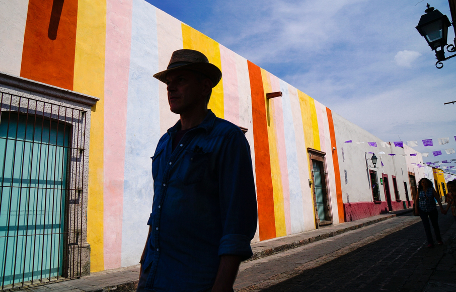 a man standing in front of a colorful building.
