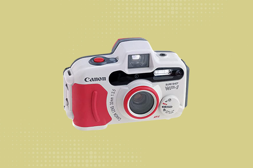 Canon Sure Shot camera on a yellow background.