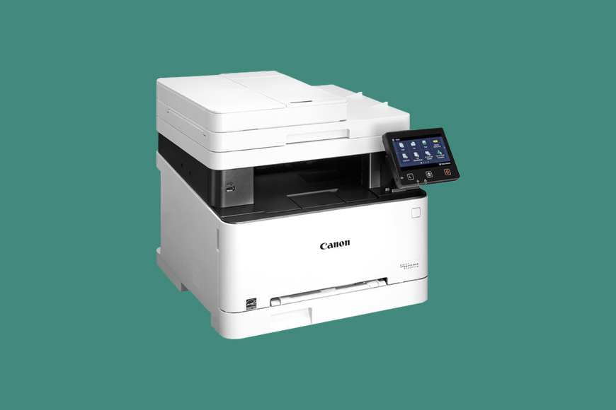 a Canon imageCLASS MF644Cdw printer on a green background